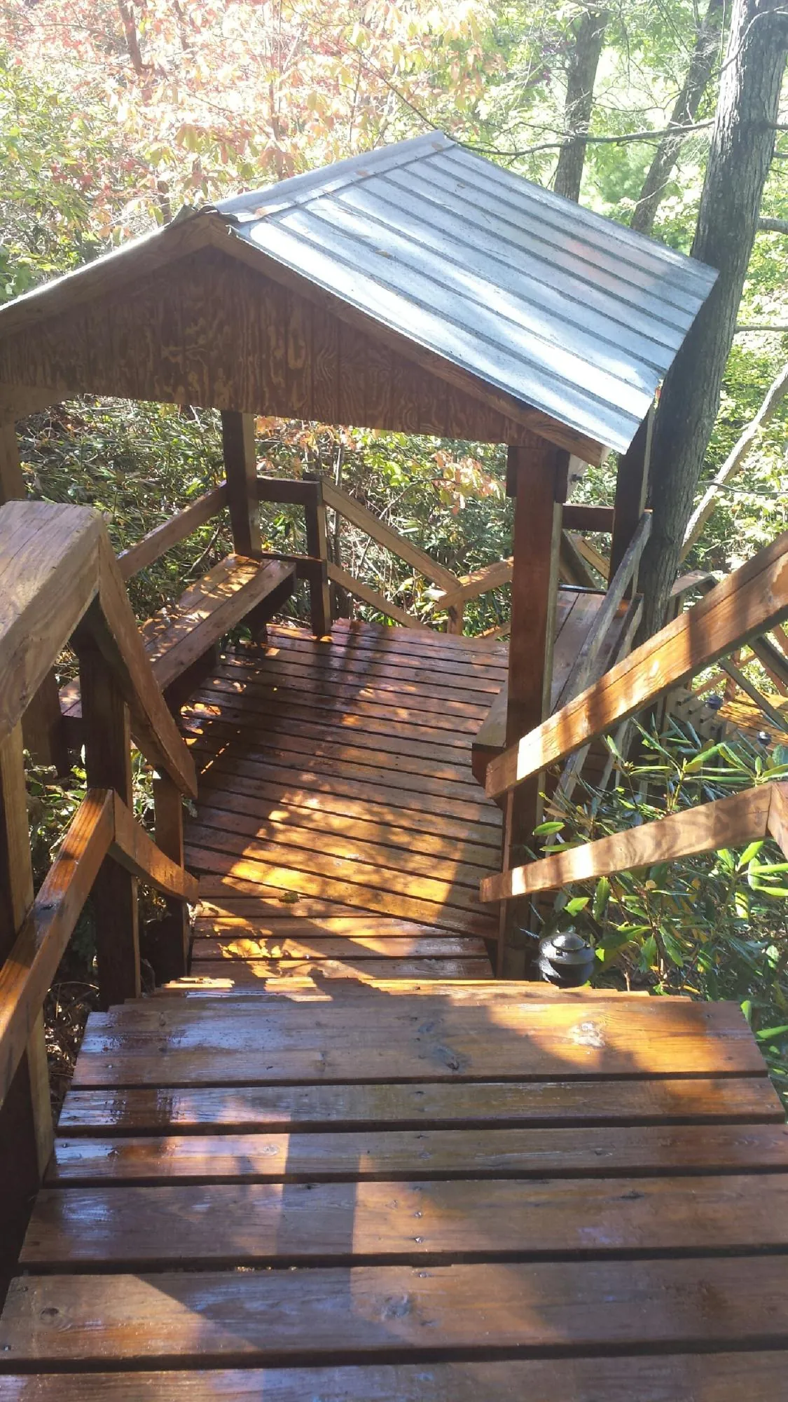 Freshly stained wood walkway and covered shelter with a metal roof in Peachtree City