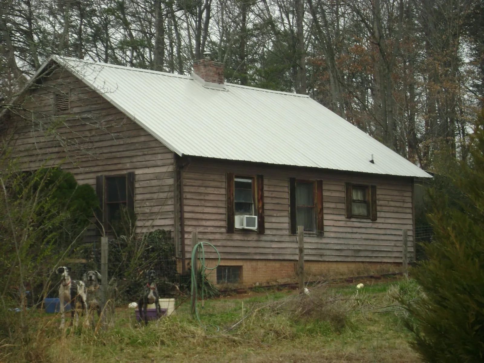 White metal roof on an old wood sided farmhouse, from a Metal Roof Installation job in Peachtree City